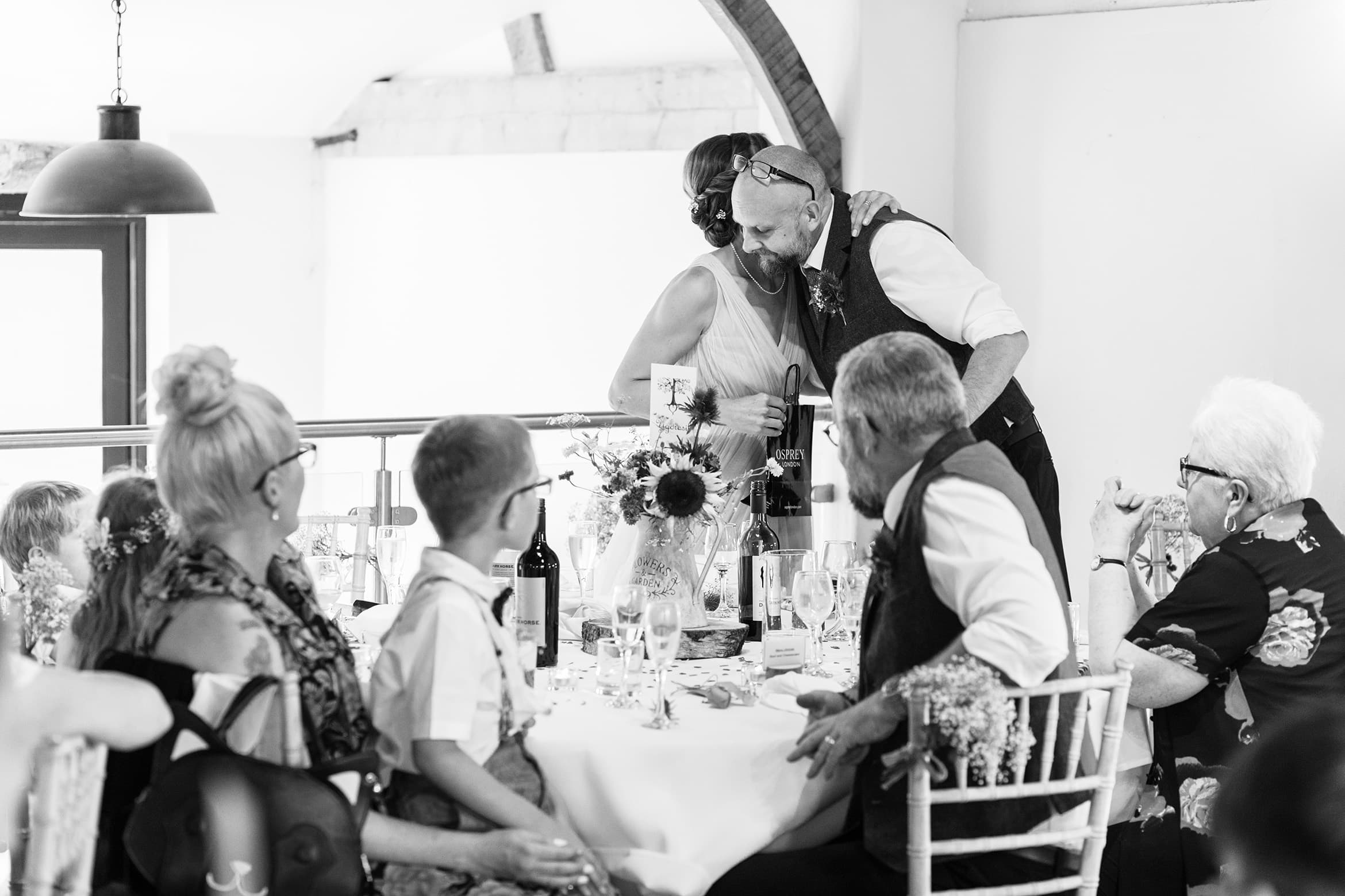 the groom hugs the bridesmaid