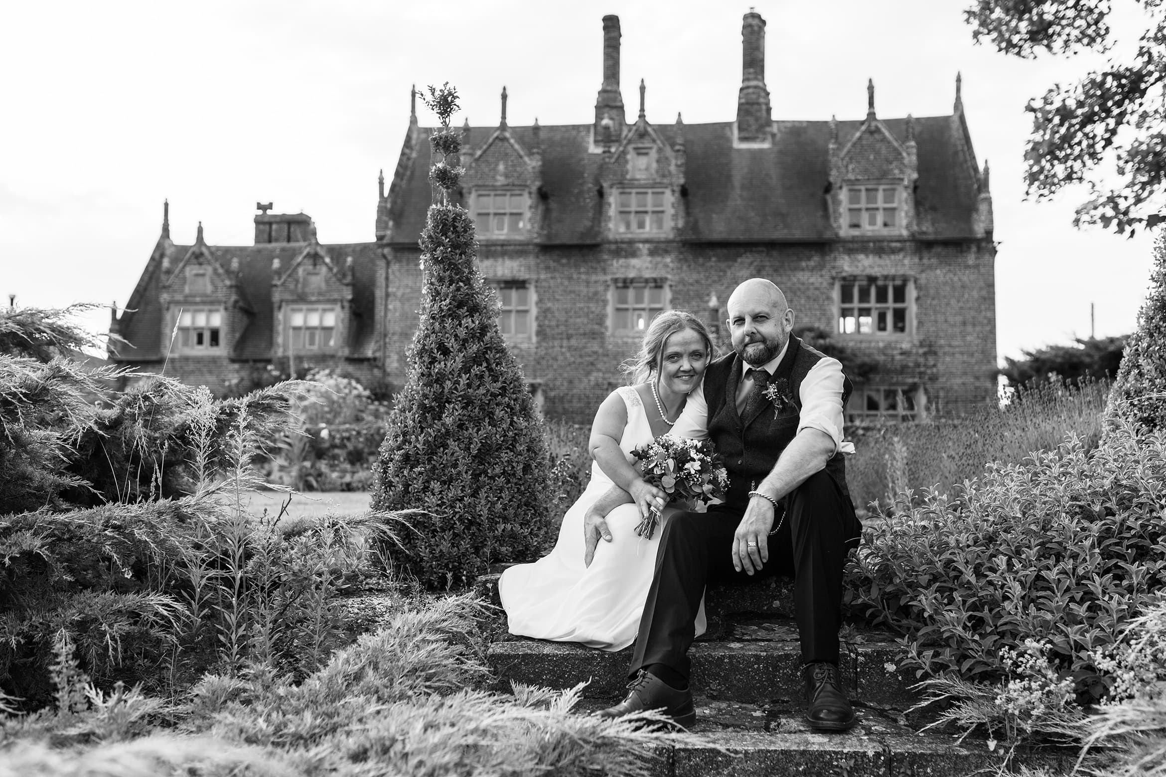 bride and groom sit in front of the hall