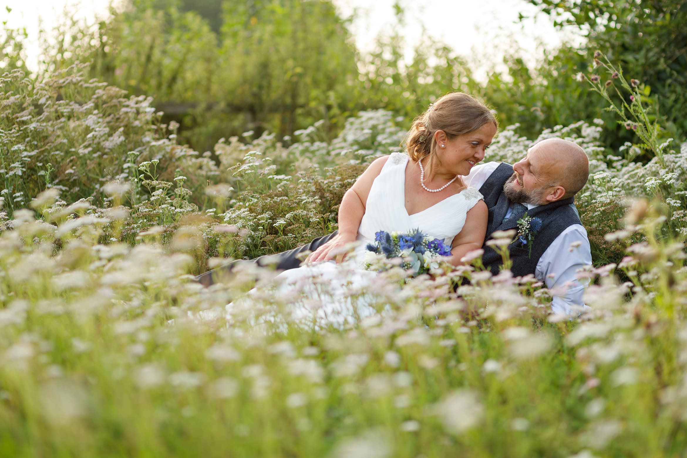 bride and groom in the flowers