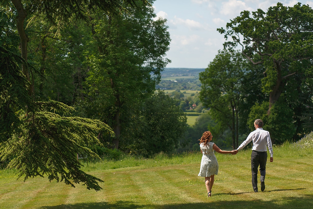 debbie and micoslav walk through the grounds of hedsor house