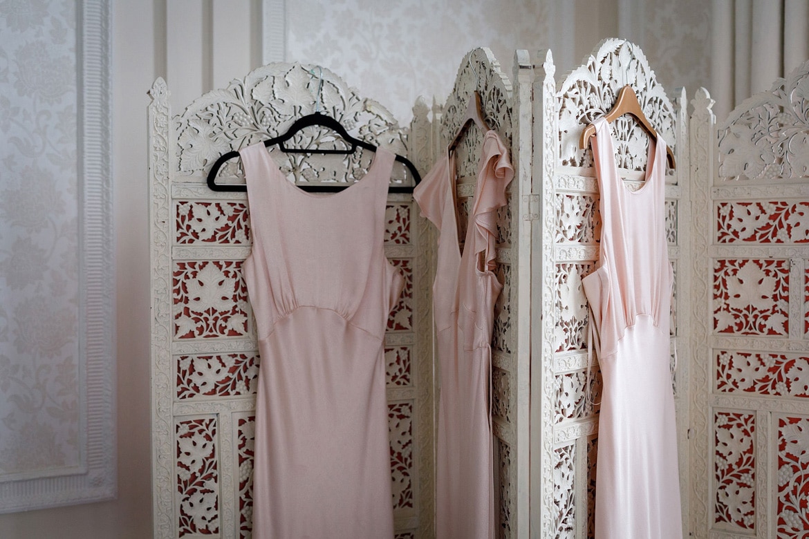 bridesmaid dresses hanging in the bridal suite