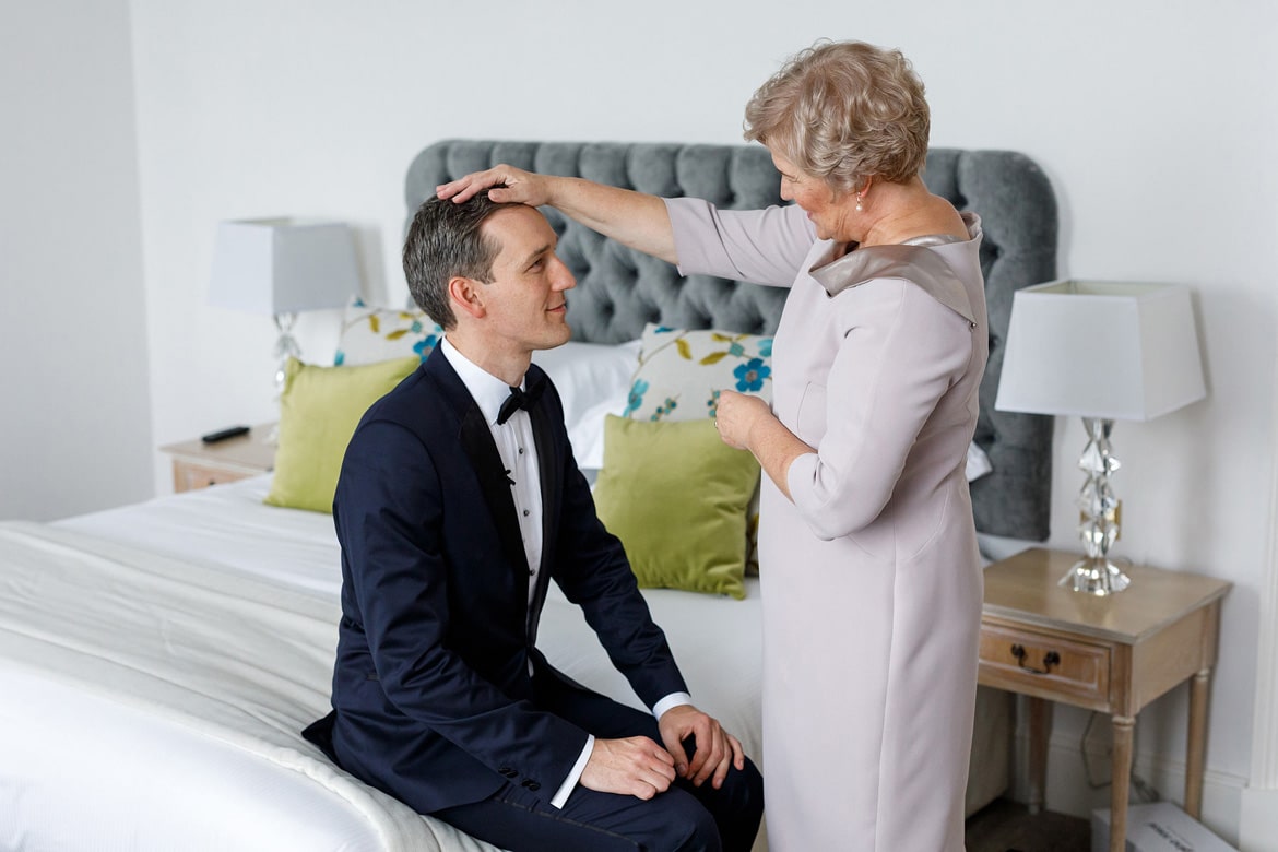 the grooms mother gives him a blessing before the wedding