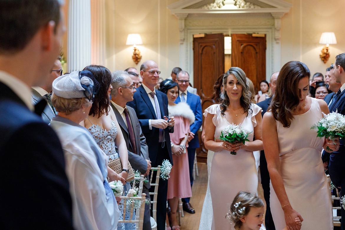 a bridesmaid pulls a face at the groom