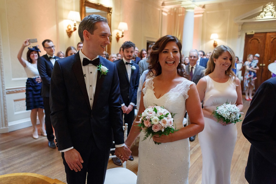 the bride arrives at the top of the aisle