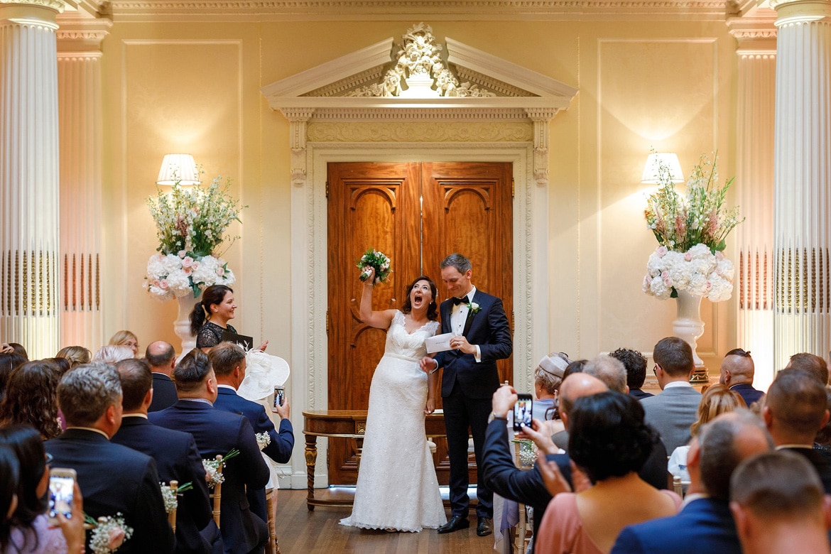 bride and groom cheer in the centre hall