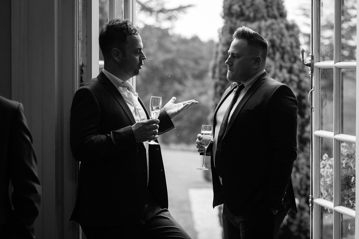 two guests backlit in a doorway