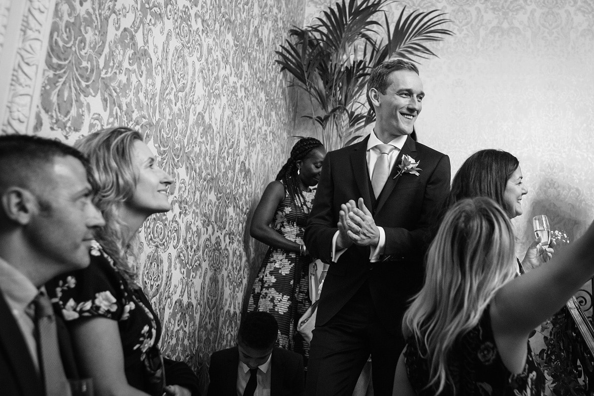 the groom makes his way down the main stairway