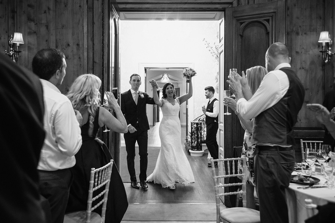 bride and groom enter the wedding breakfast