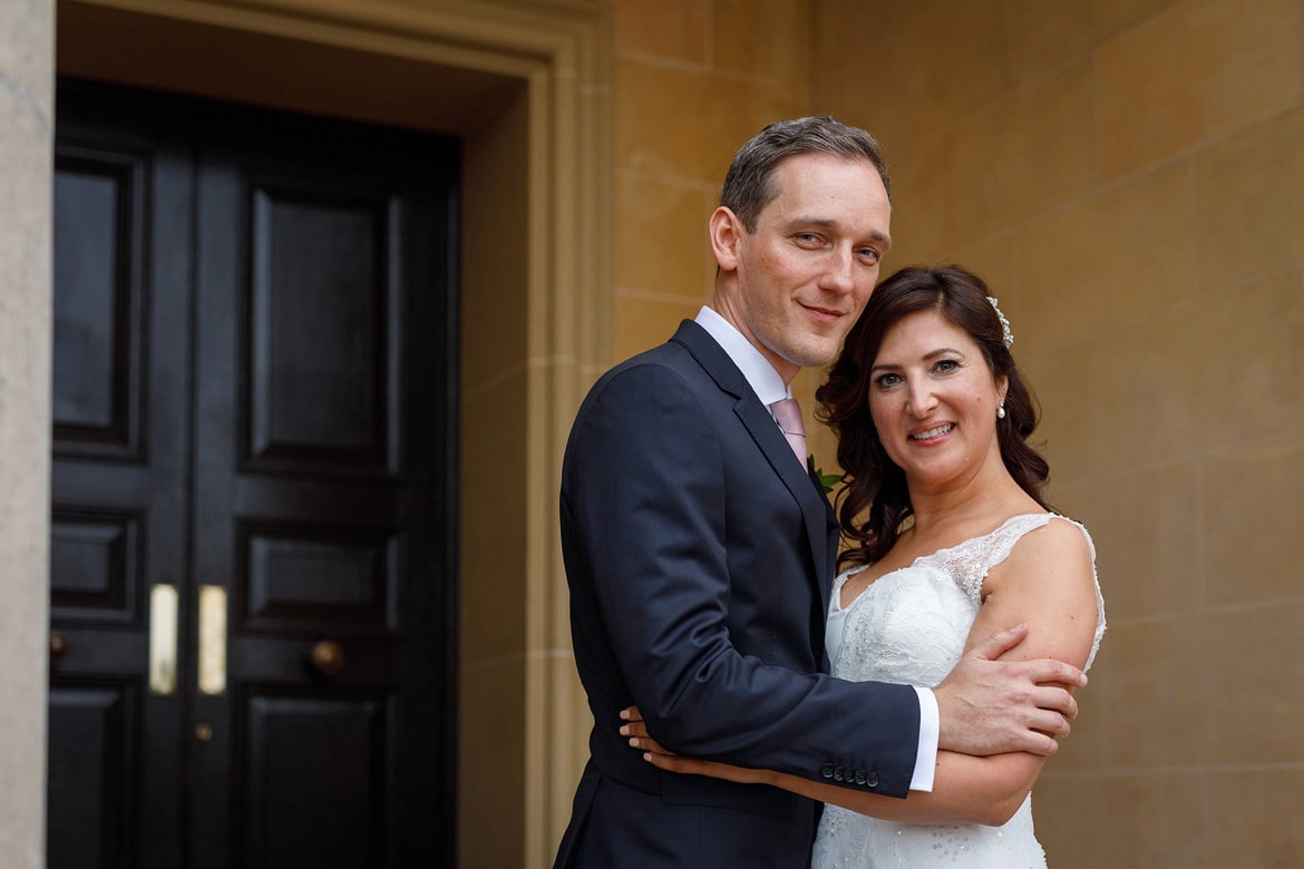 a wedding portrait on the steps of hedsor house