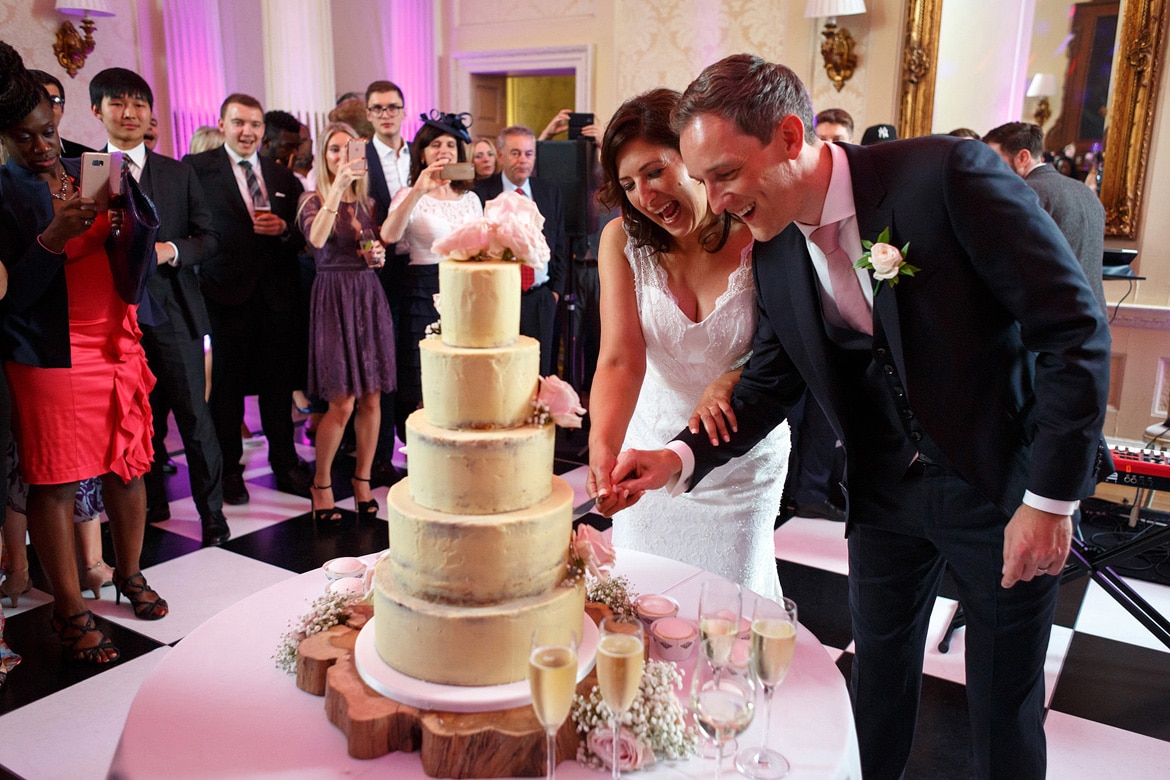 cutting the cake at a hedsor house wedding