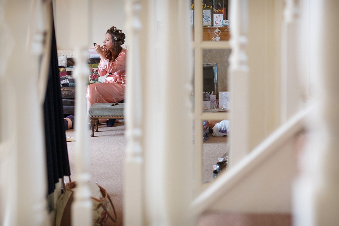 laura applying her makeup before the wedding