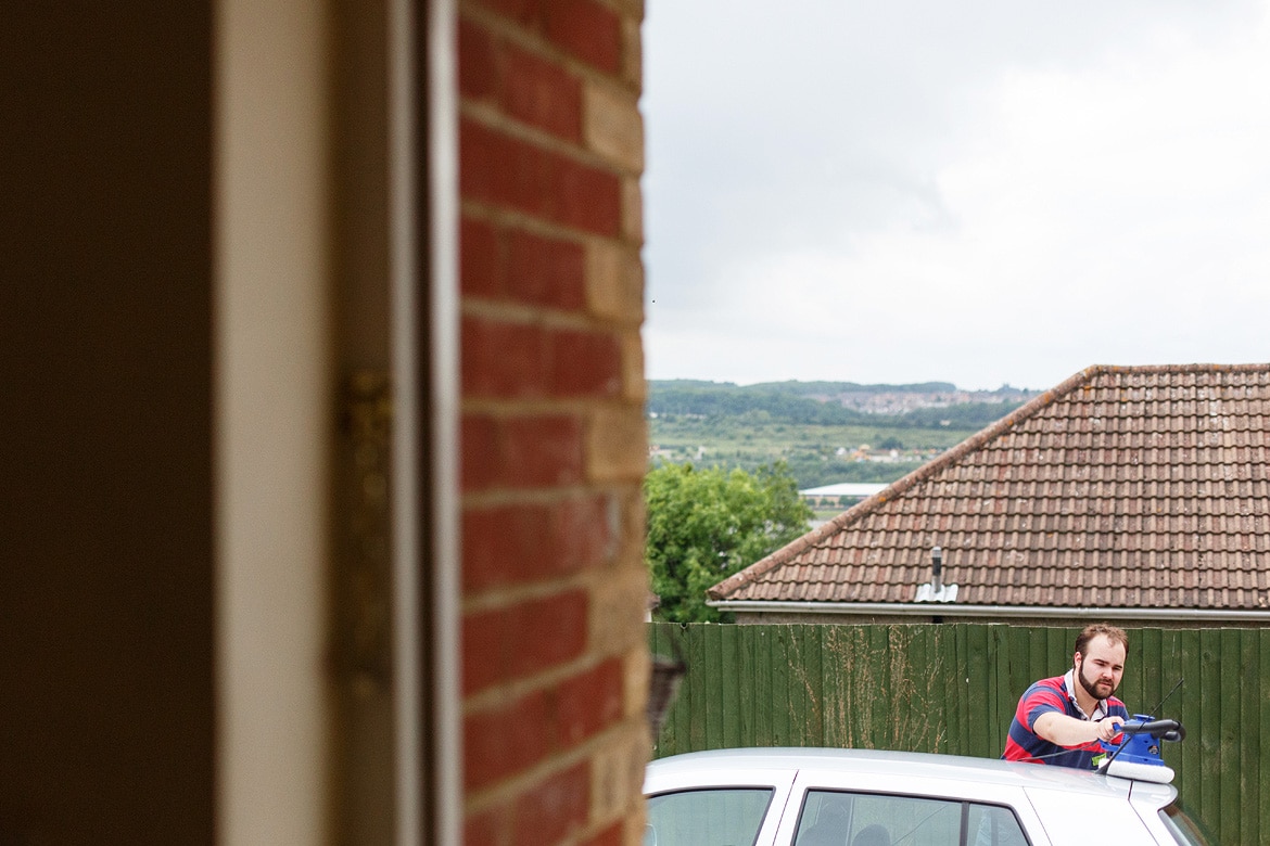 the brides brother prepares the wedding car