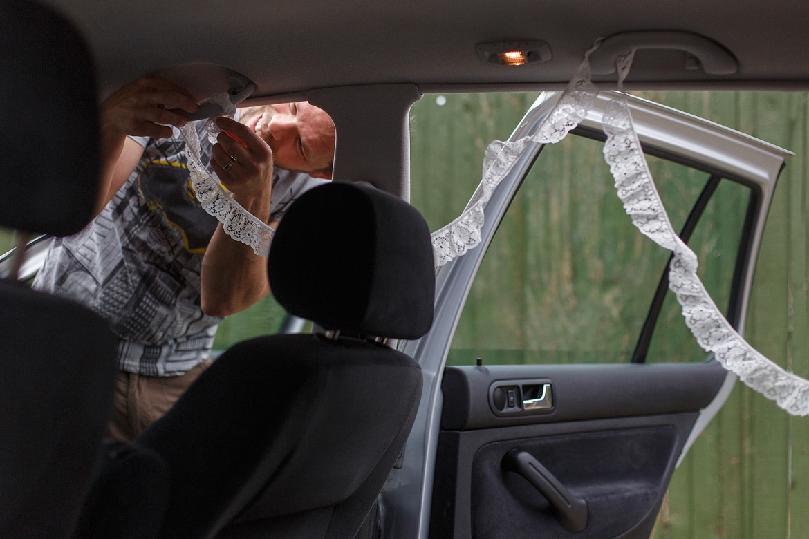 the brides brother prepares the wedding car