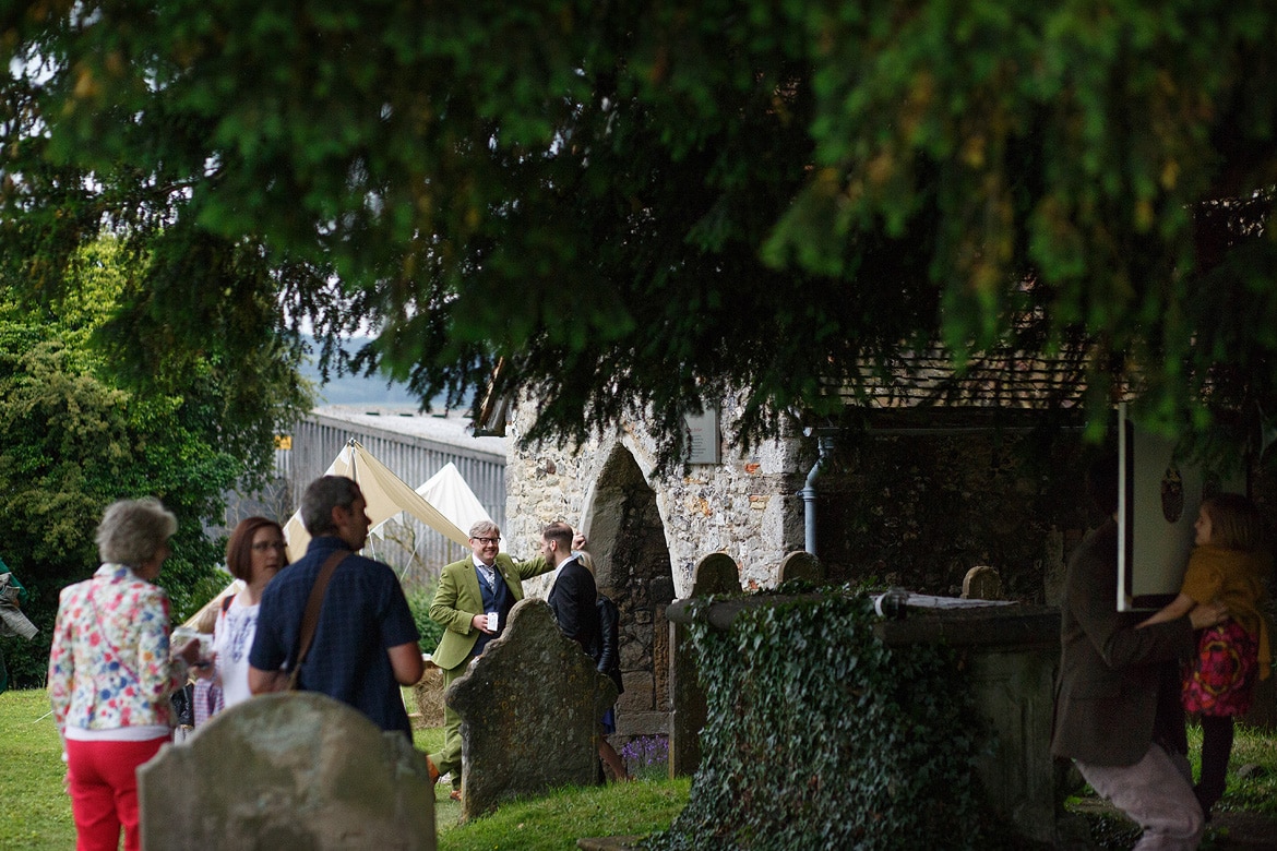 the groom welcomes guests at the church