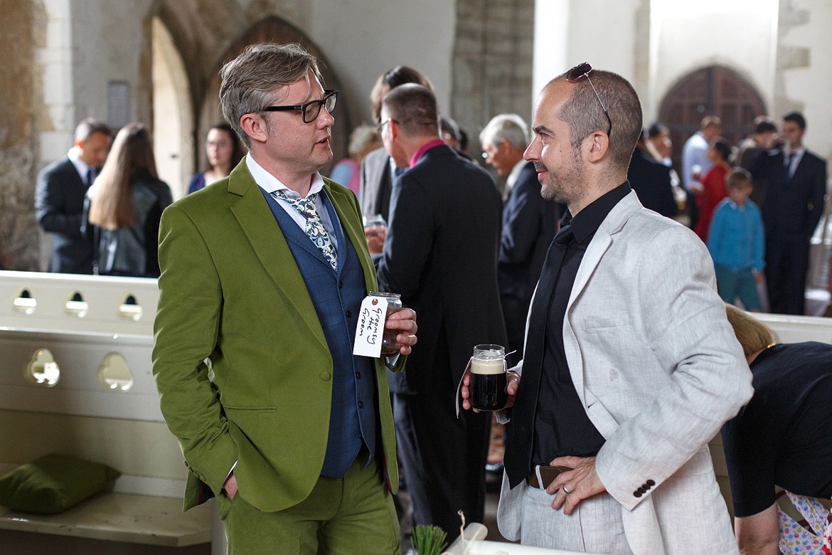 the groom talks to a guest