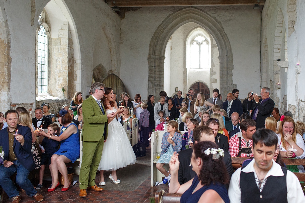 the bride and groom with their guests during the ceremony