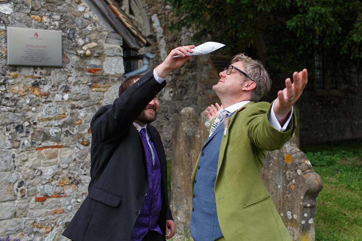 a guest throws confetti over the groom