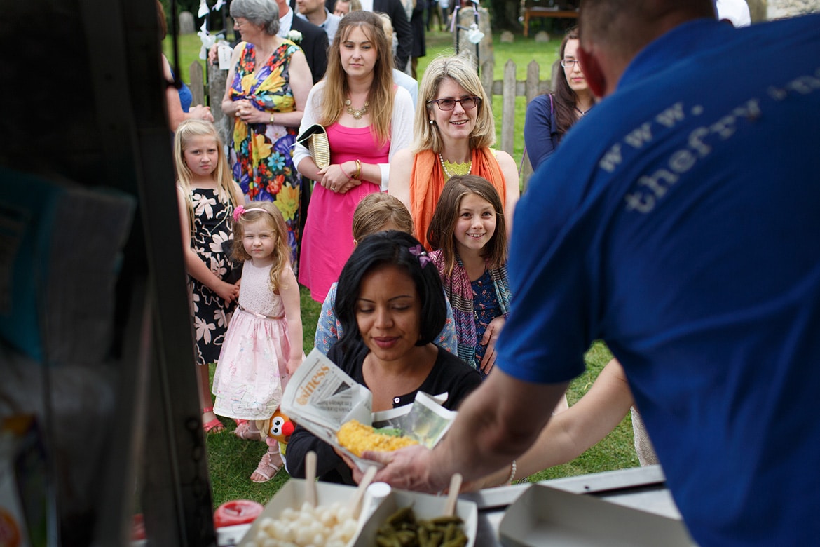 wedding guests queueing for their fish and chips