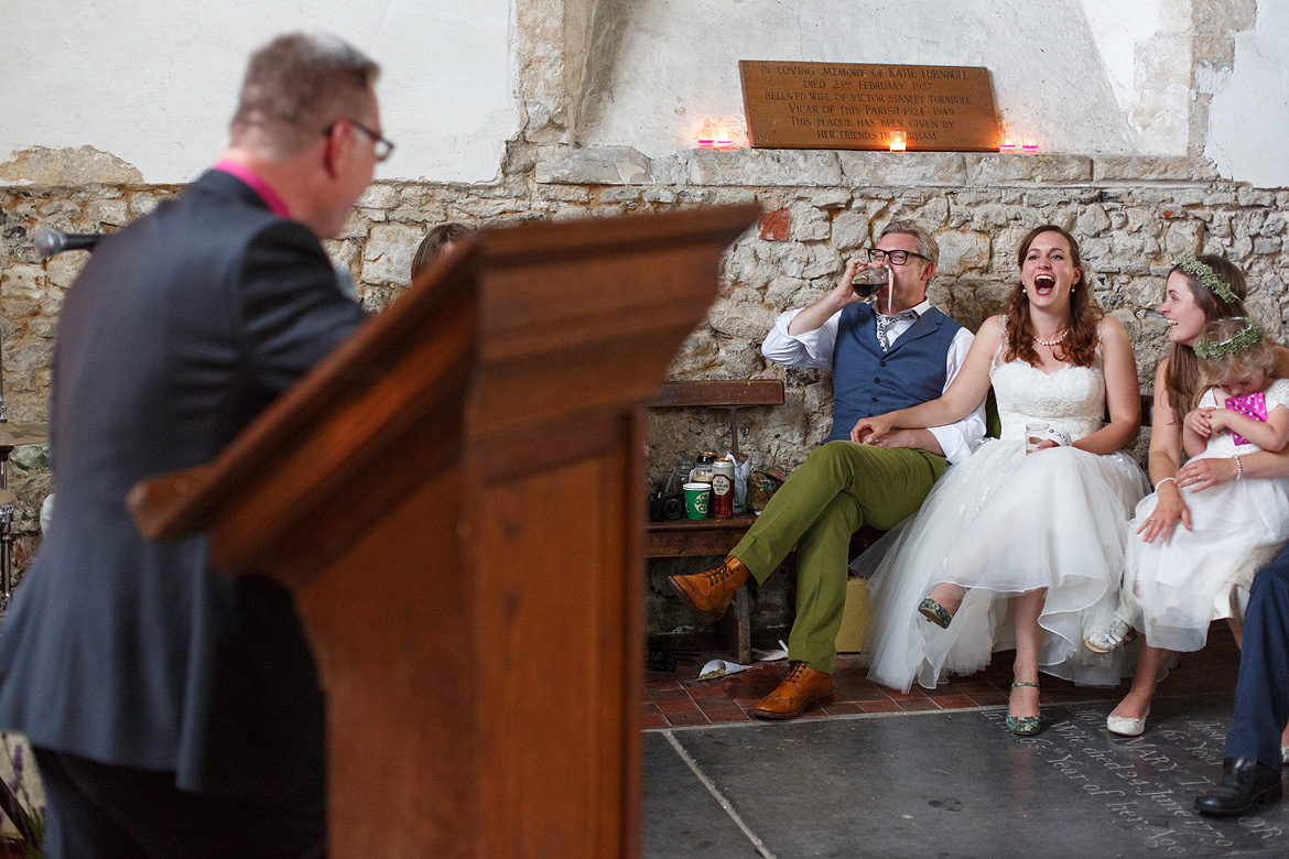 bride and groom laugh at the best man