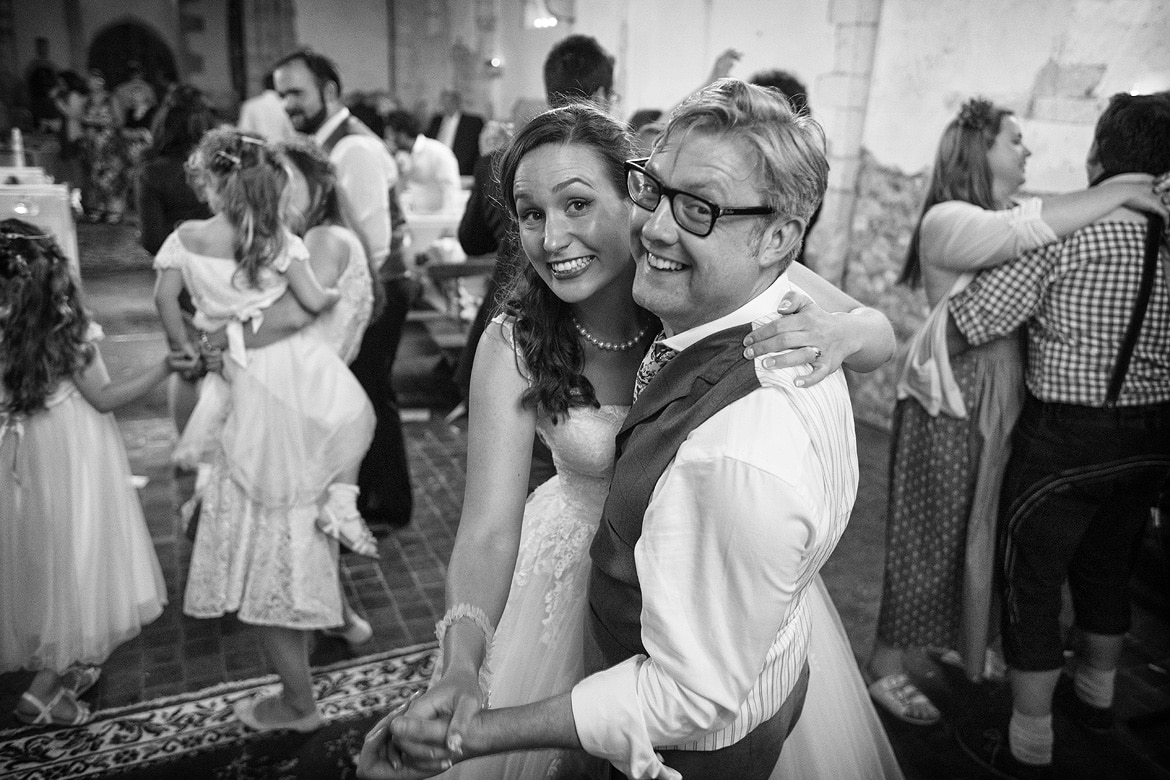 bride and groom smiling at the camera