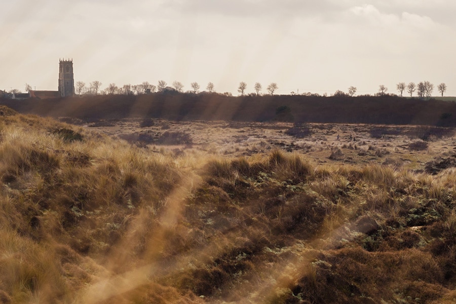 a landscape photo from the dunes at winterton looking back to the church