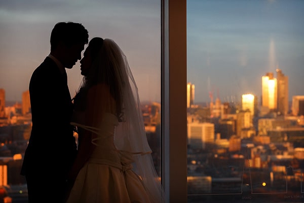 bride and groom silhouette in front of a london skyline