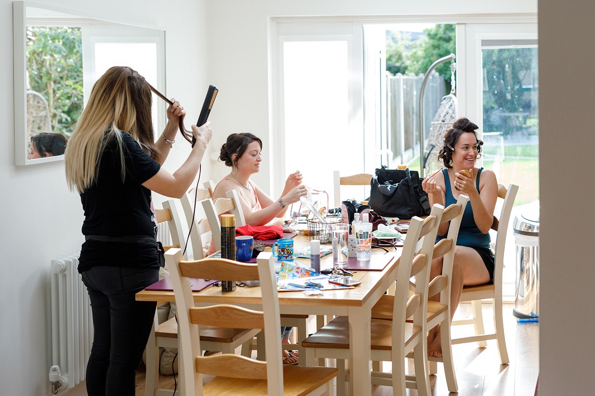 the girls all sitting round the table doing their makeup