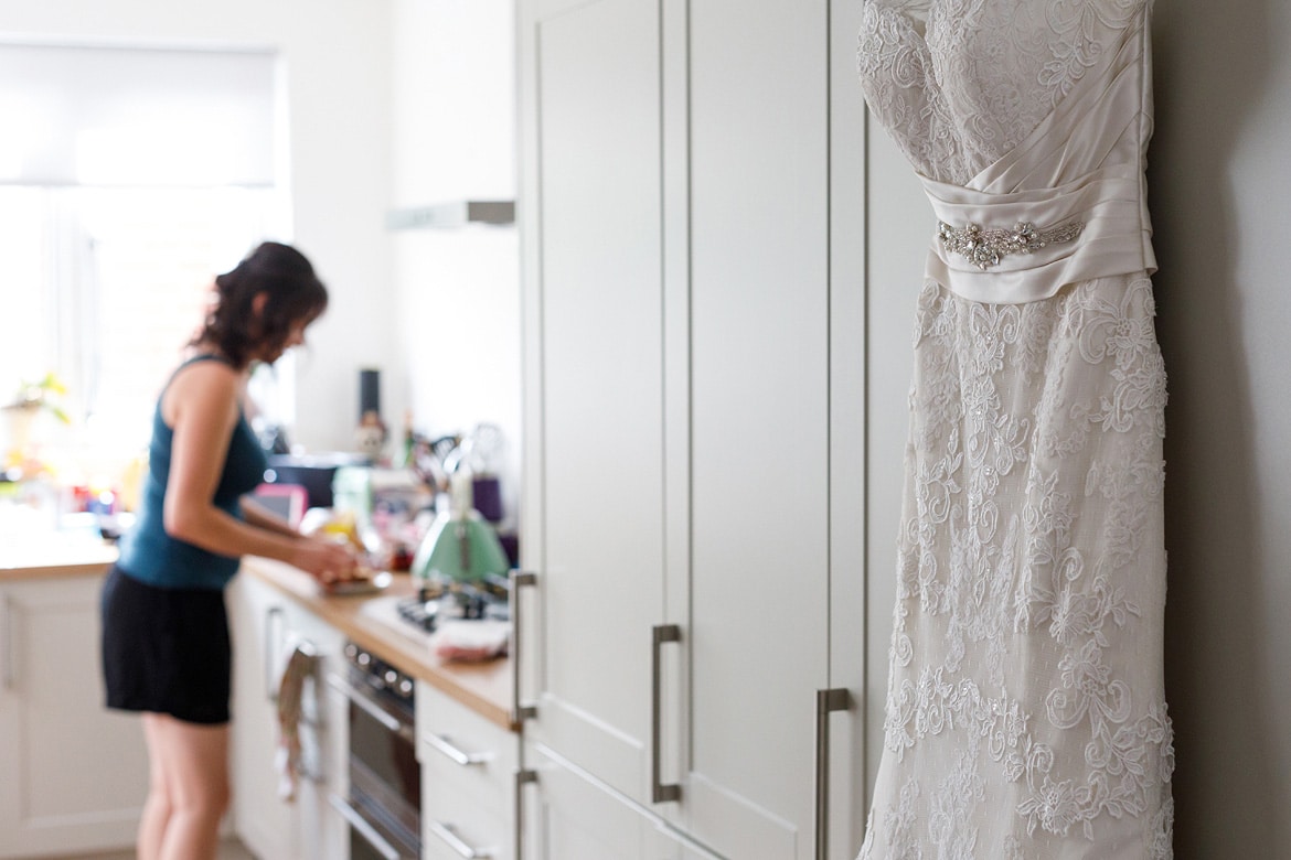 the wedding dress with the bride in the background