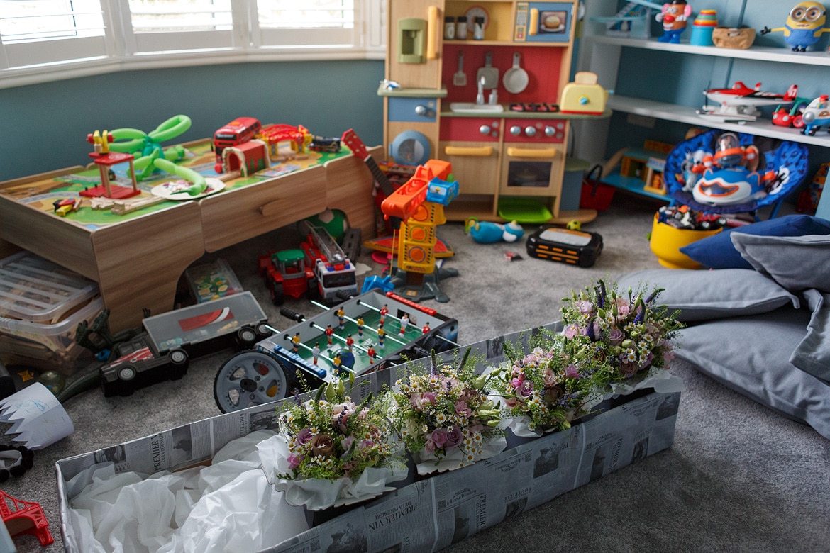 the girls flowers stored in the play room with toys all around