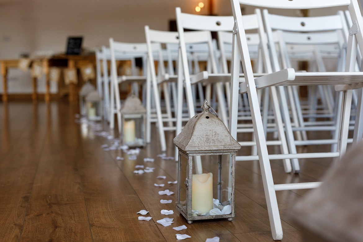 lanterns and rose petals line the aisle