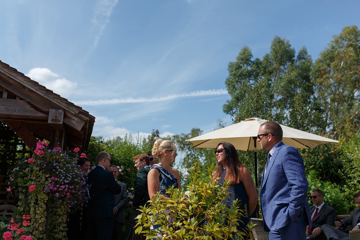 guests chat in the sunshine before the ceremony