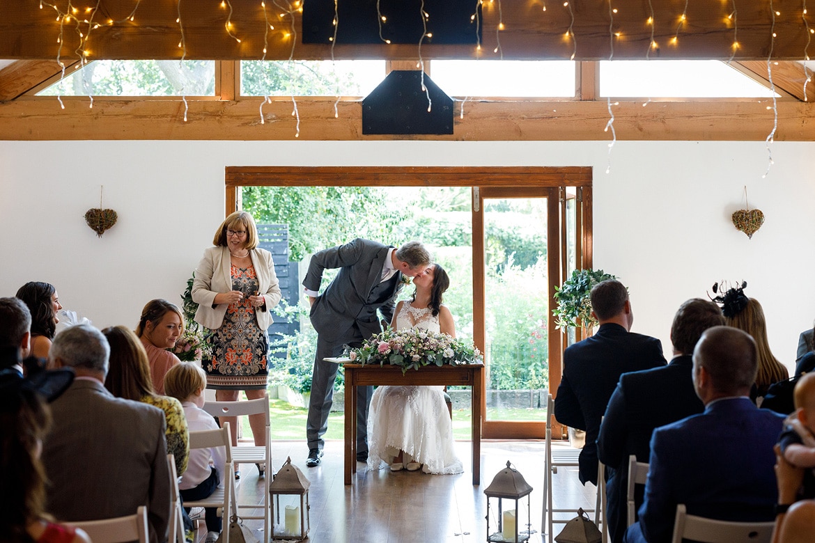 the couple kiss before signing the register