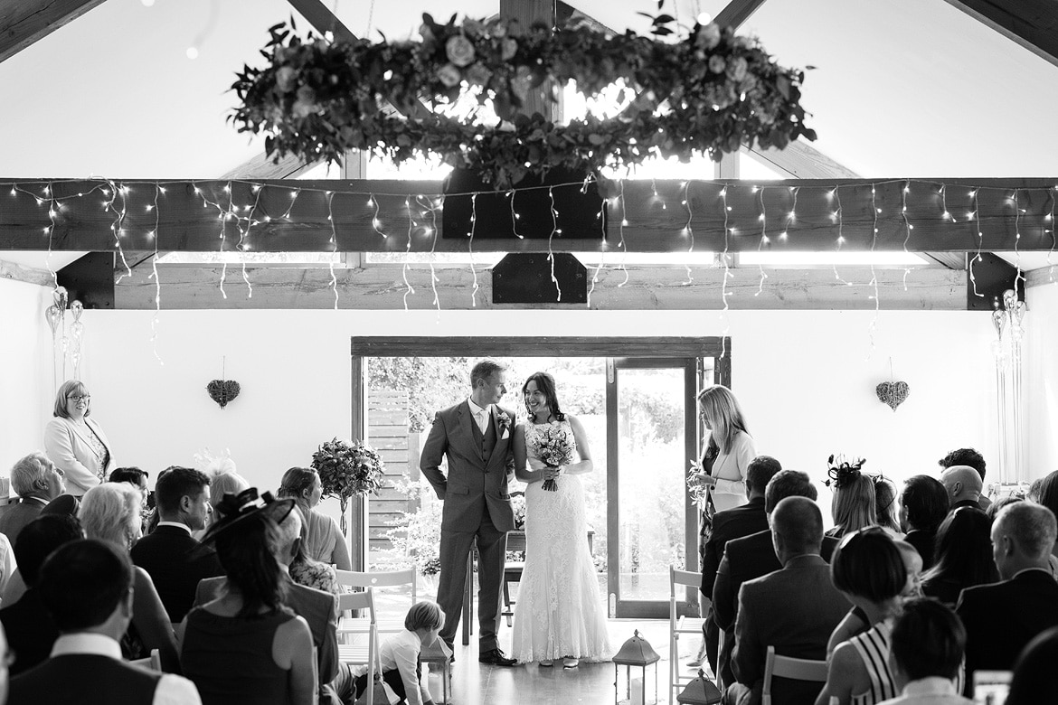 bride and groom smile at the end of the their ceremony