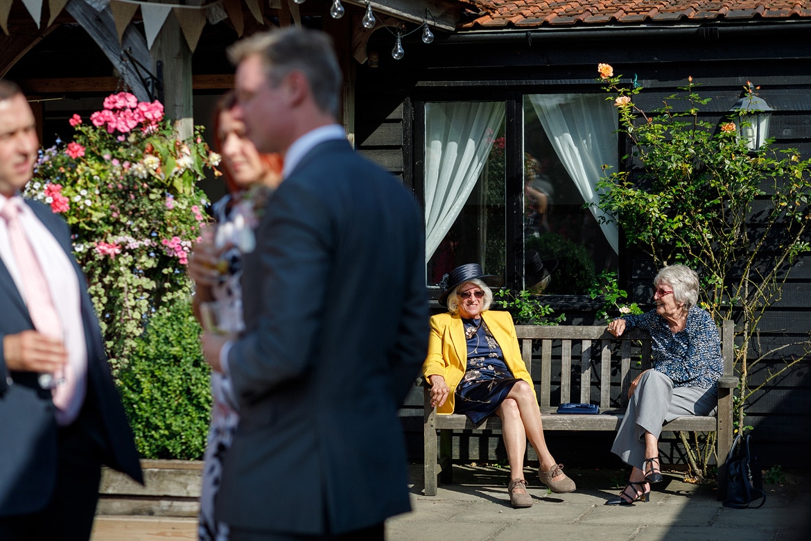 wedding guests sitting in the sunshine