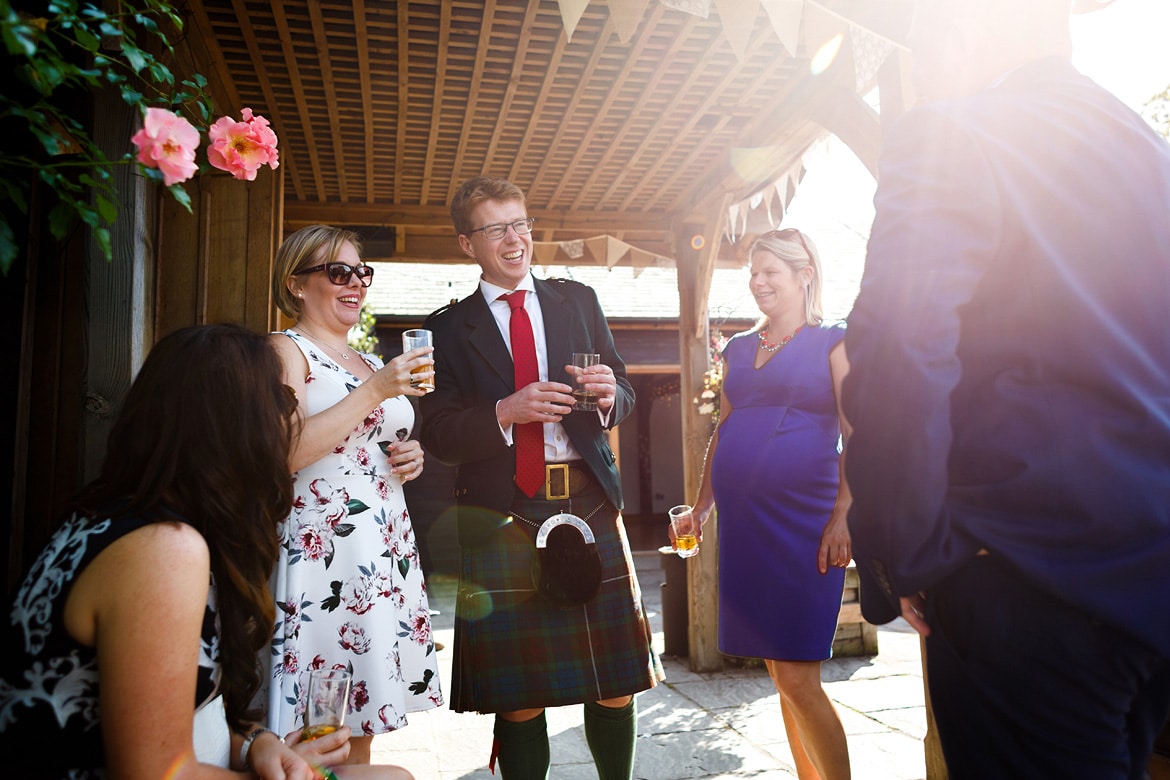 wedding guests chat in the sun