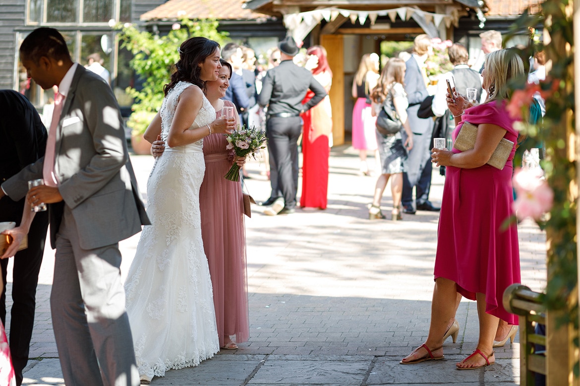 the bride poses for photos with her guests