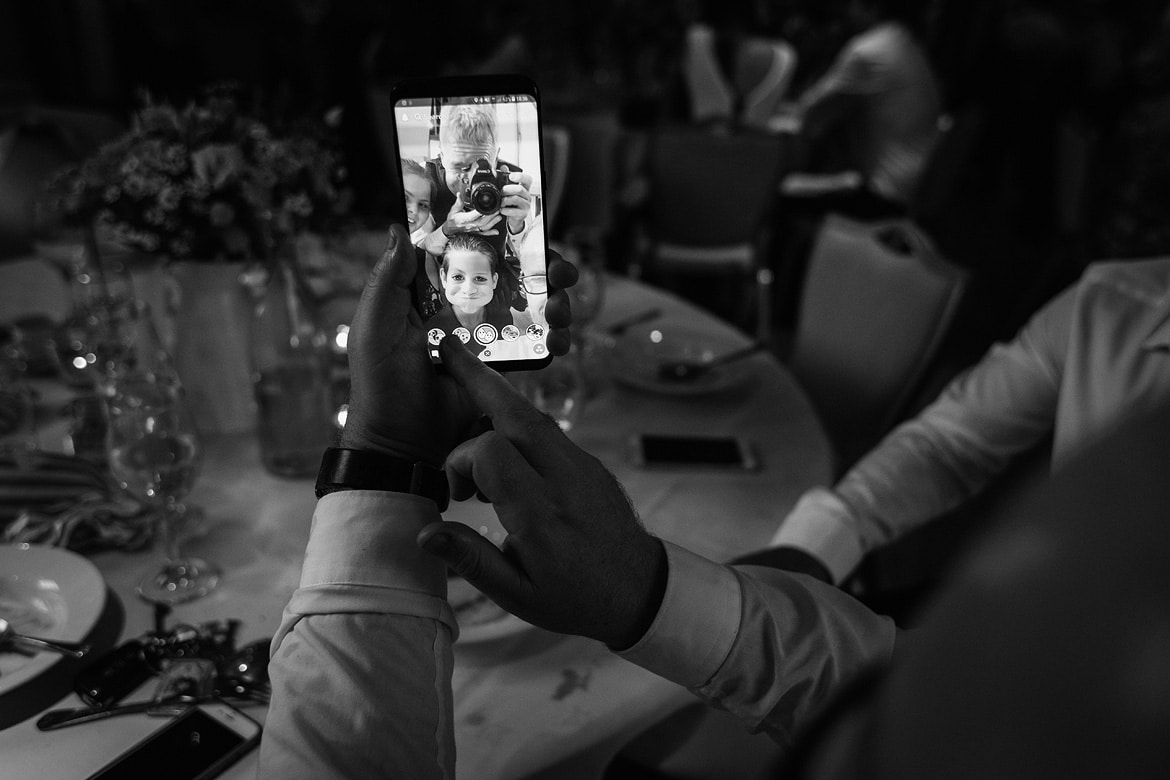 the wedding photographer caught in a guests phone