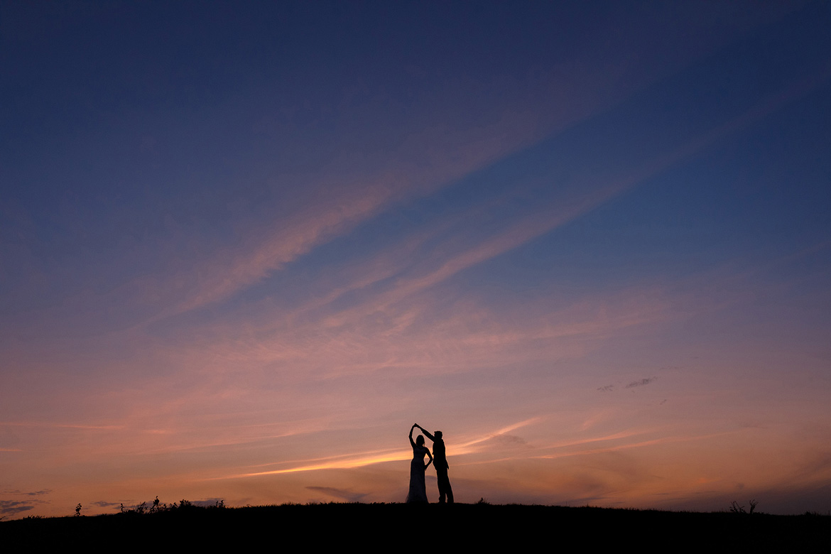 a silhouette sunset portrait at a maidens barn wedding