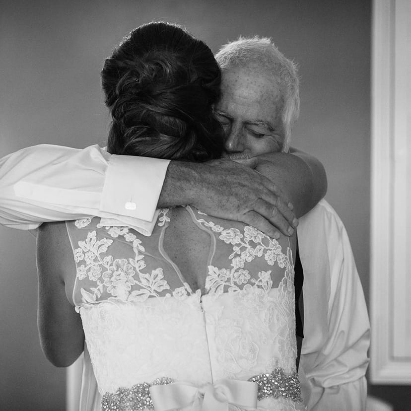 a bride hugs her dad