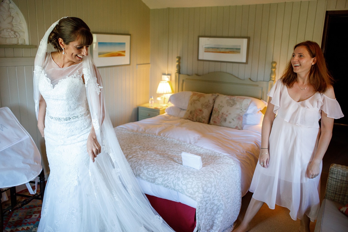 the bride shares a joke with her bridesmaid