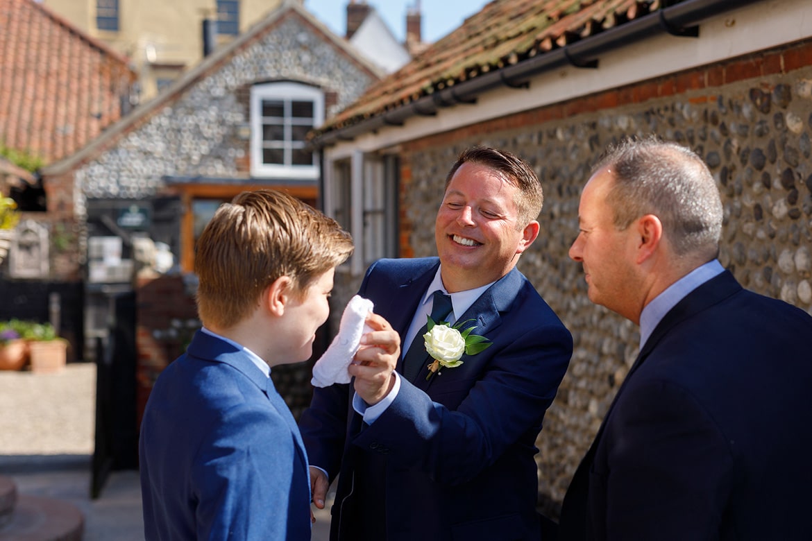 the groom helps his son cool off