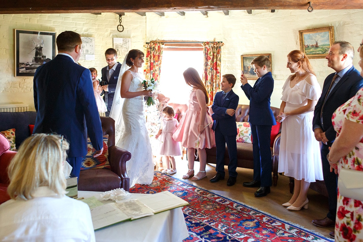the bride enters the ceremony room for her north norfolk wedding