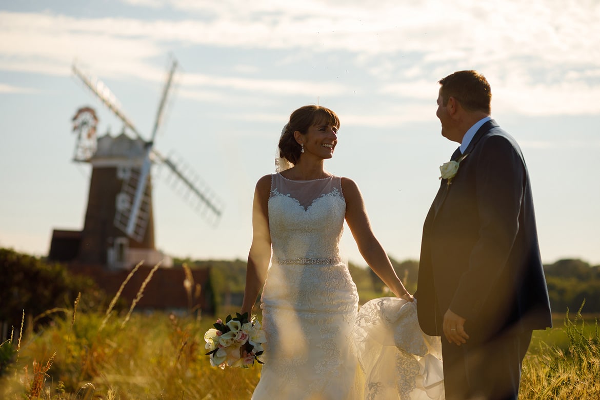 bride and groom with the windmill in the background
