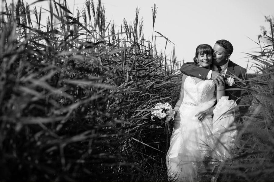 eva and mark in the reeds at their cley windmill wedding