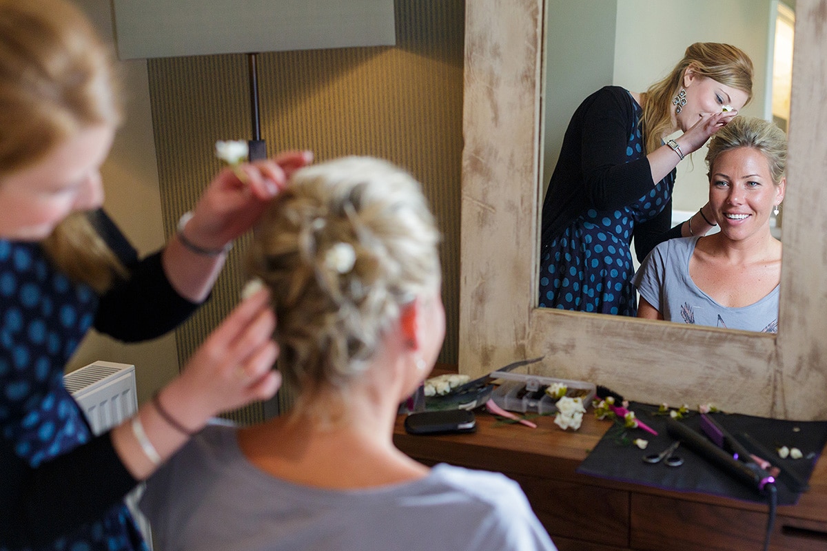 a bridesmaid having her hair finished at godwick hall