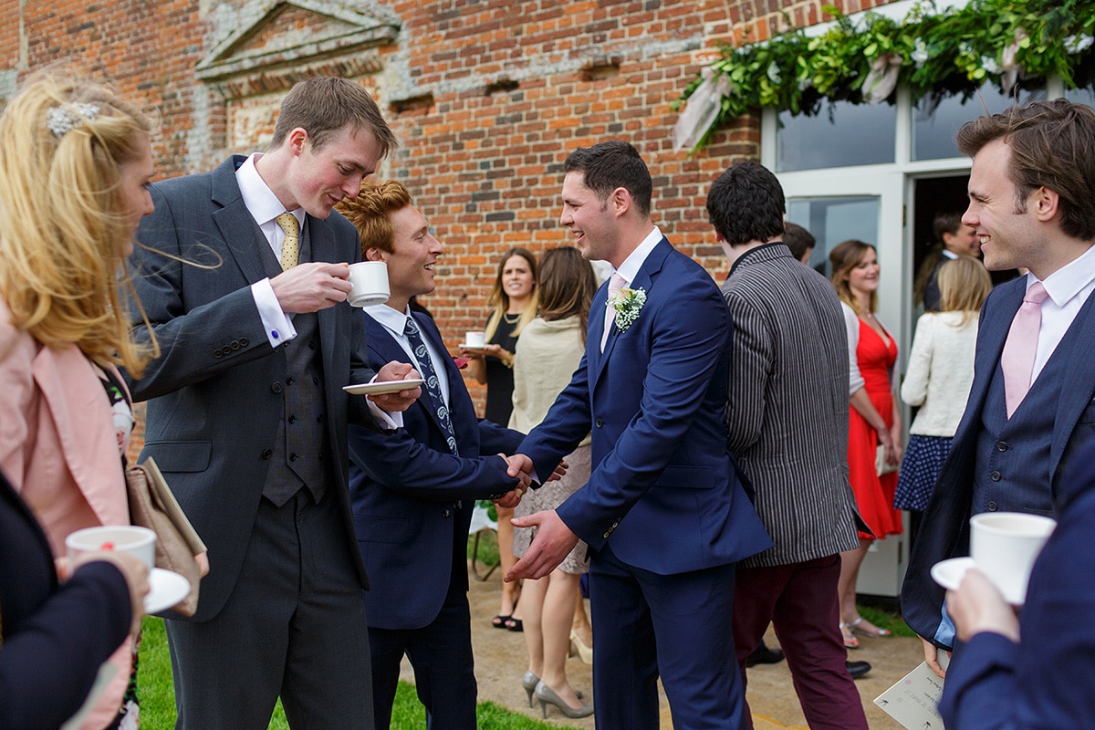 the groom greets guests before the ceremony