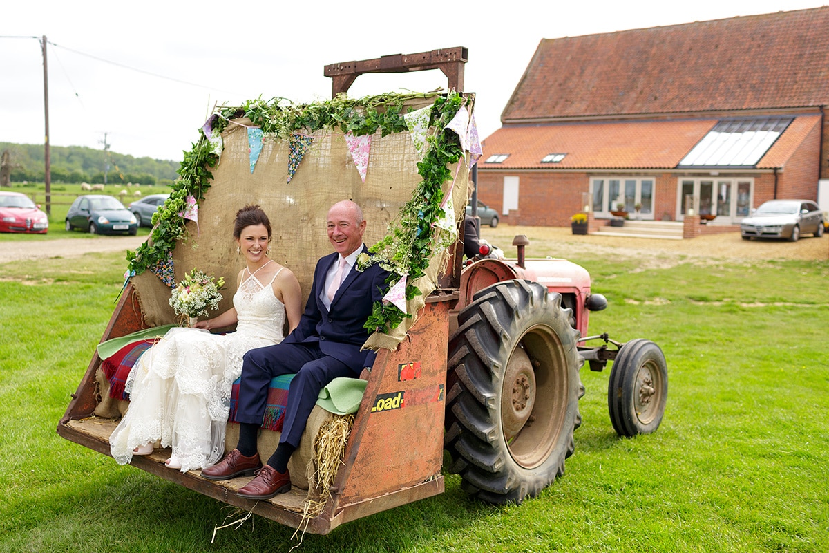 the bride and her father arrive in the godwick tractor