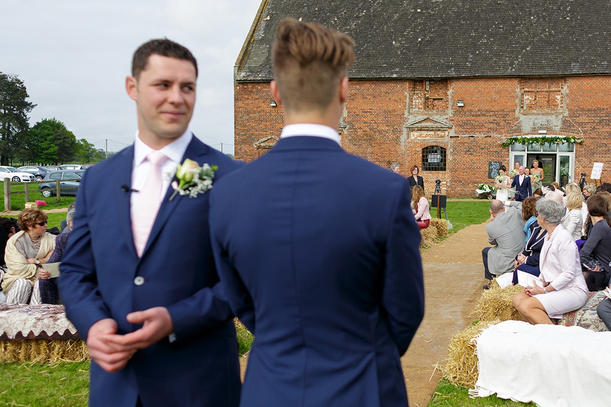 the groom looks at his best man