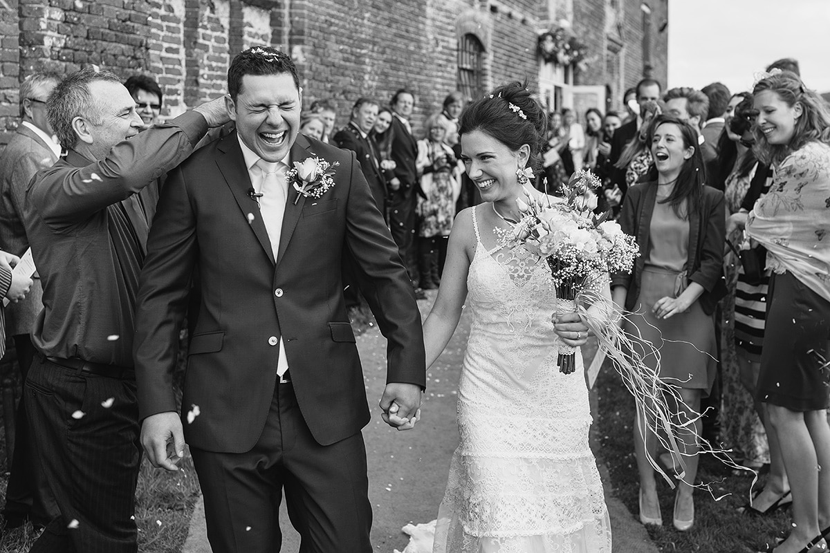 the groom has confetti stuffed in his collar