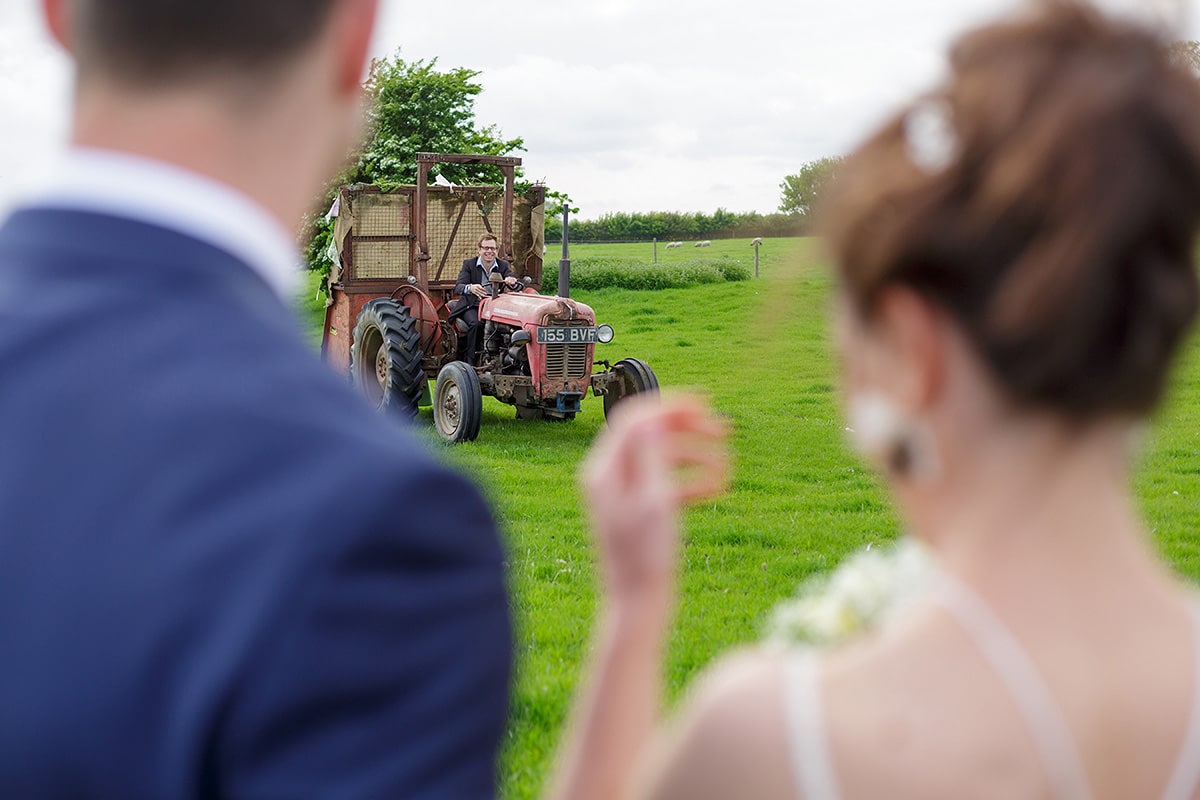 bride and groom wait for the tractor